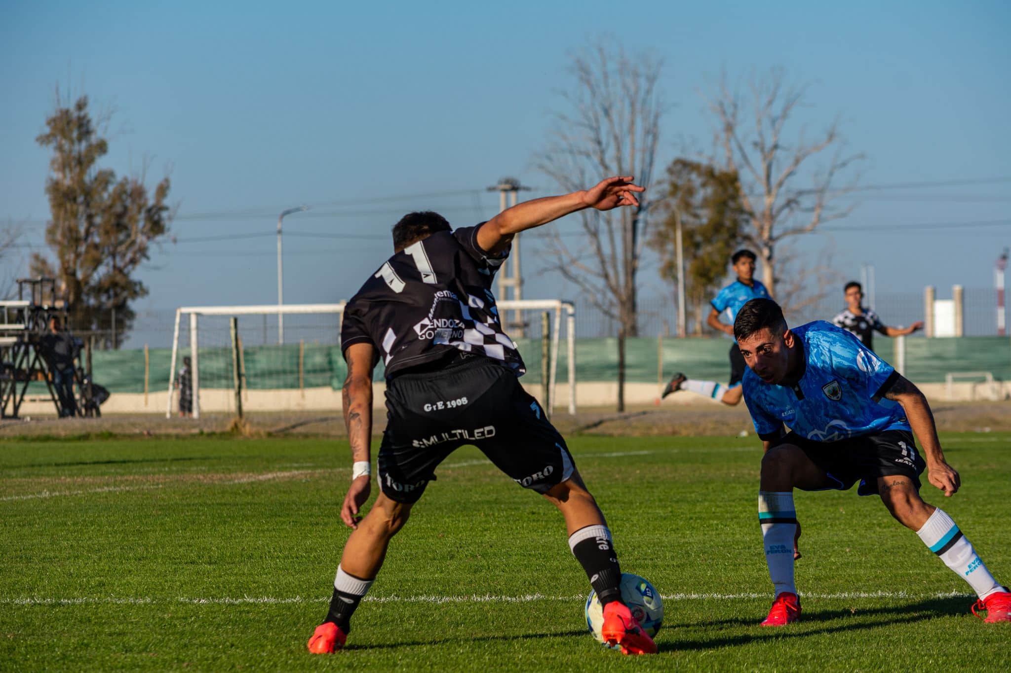Captured intense moment during a soccer match under clear skies.