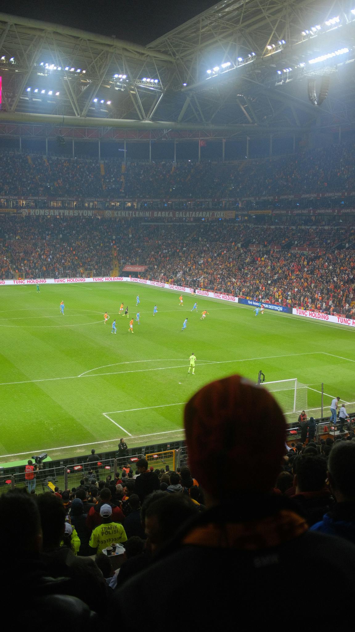 Thrilling soccer match at a packed Istanbul stadium with vibrant crowd and atmospheric lighting.
